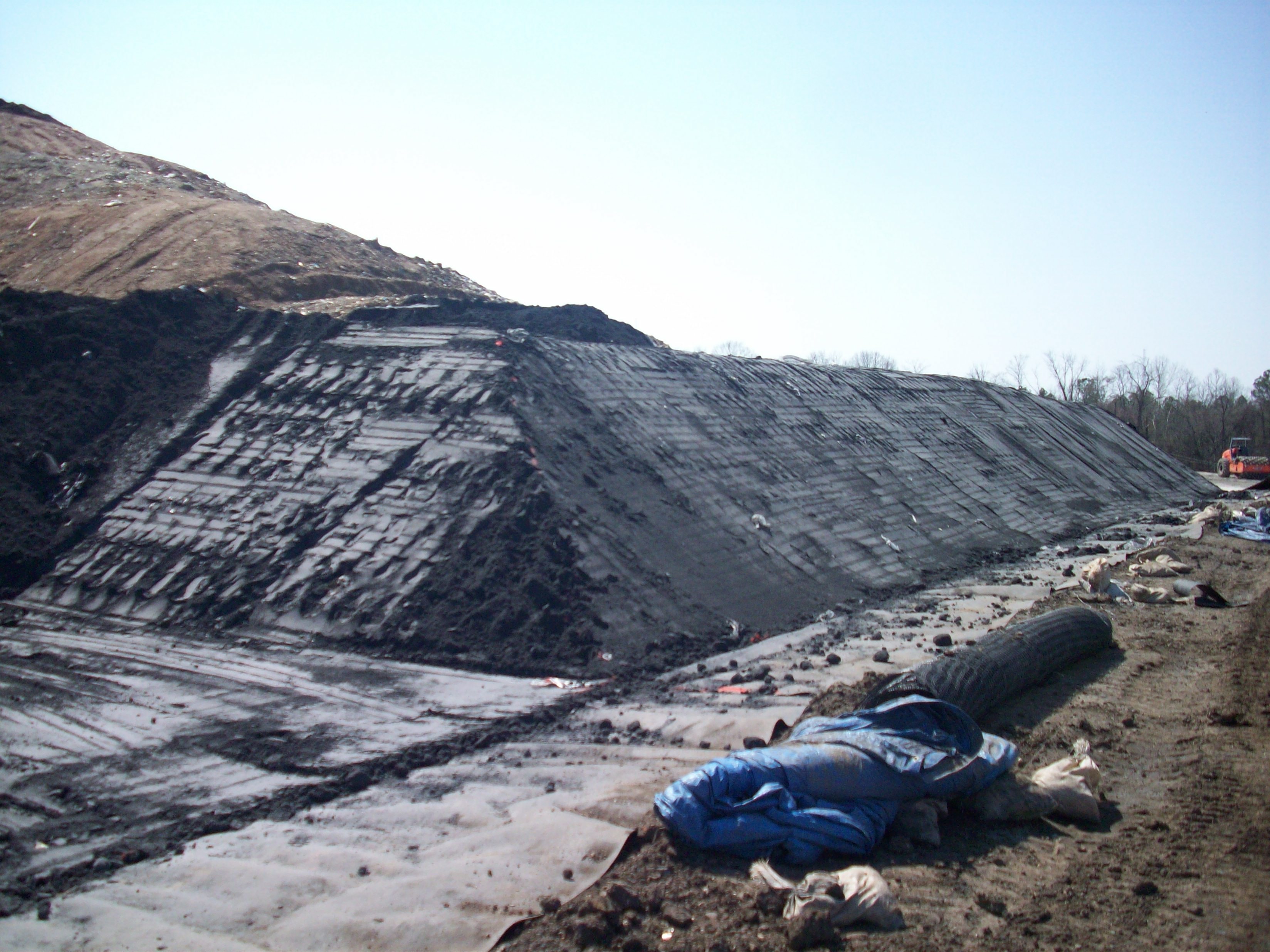 eMSE construction site with heavy equipment on earthen embankment